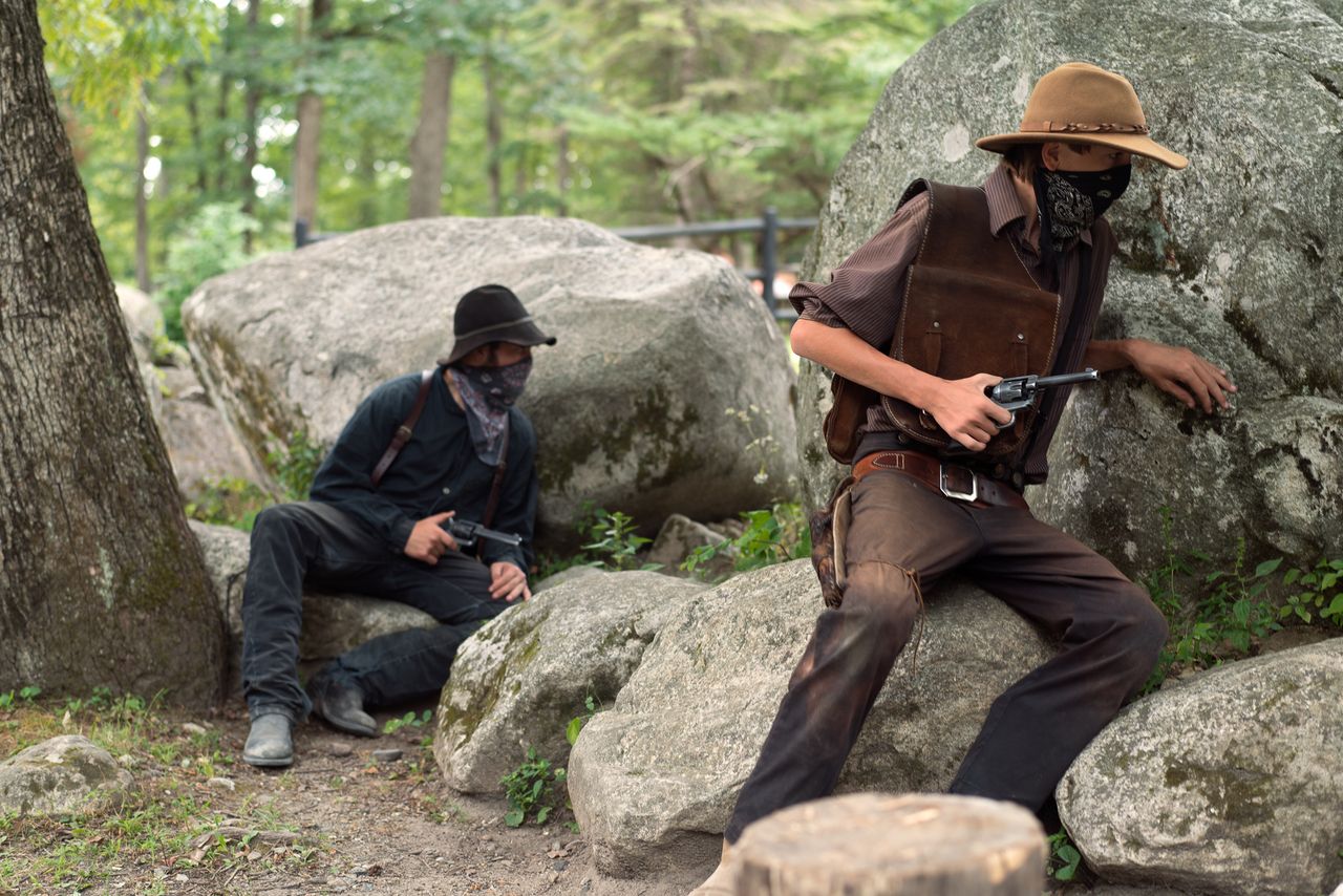 Two Wild West City actors, preparing to jump out from behind the rocks, during an audience participation skit. The men are playing bank robbers, who’ll soon be rounded by children to face the gallows.