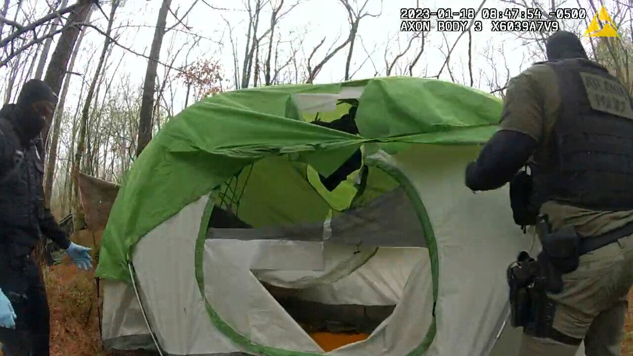 In this image taken from bodycam video released by the Atlanta Police Department, officers are seen removing and shredding items from an empty tent near the planned site of Cop City on Jan. 18.