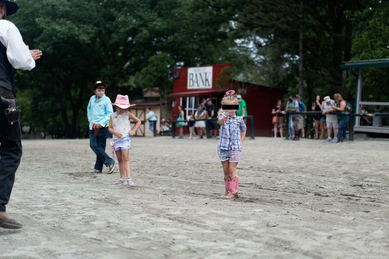 The young girl, whom I've nicknamed "Little Miss America," continued to pull the trigger, and furrowed her brow.